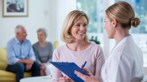 A medical consultation depicting a happy healthcare customer.